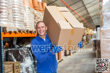 Positive warehouse worker dragging boxes on hands