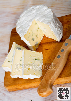 Creamy blue cheese on wooden board