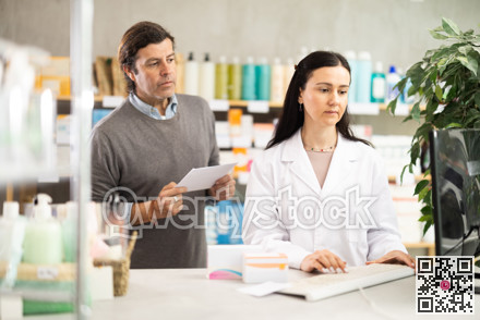 man with a medical prescription consults a pharmacist
