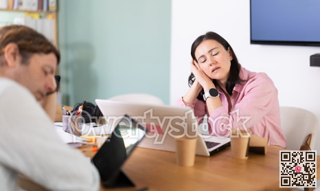 Tired man and woman colleagues fall asleep while working