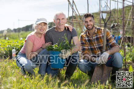 Portrait of happy family with an adult son and harvest of onions in their hands