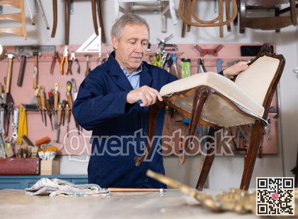 Ole male furniture workshop worker designing vintage chair