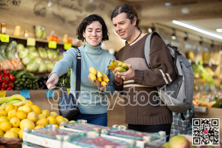 European couple standing near banana counter