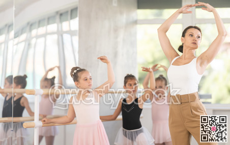 Teacher dancer performing pirouette in front of class