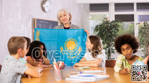 Friendly female teacher tells the pupils the history of Kazakhstan