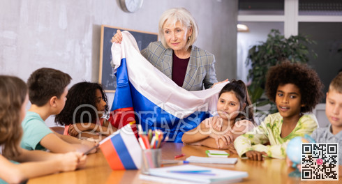 students listen to woman teacher who talks about Russia