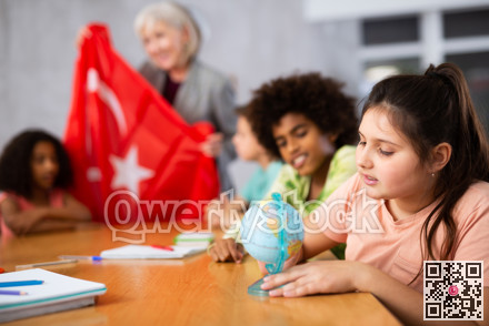 students listen to woman teacher who talks about Turkey
