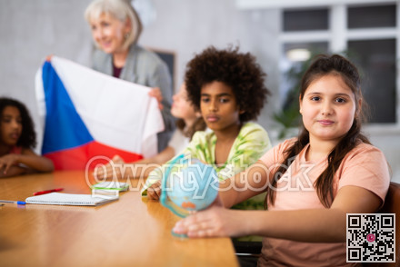 students listen to woman teacher who talks about Czech