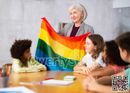 Female teacher showing rainbow flag to kids in geography class