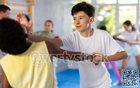 Two boys practicing self-defense techniques