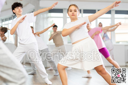 Group lesson in choreographic studio - teenagers learn to dance hip hop and modern dances