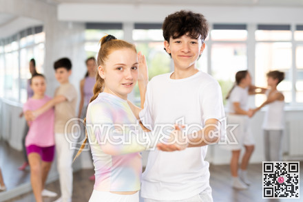 Teenage boy and girl dancing waltz