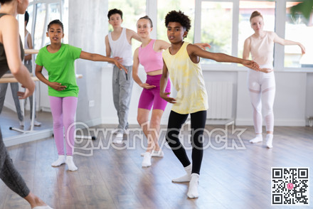 African american teen boy participating in beginner group ballet class