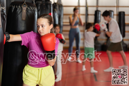 Teen girl training with punching bag
