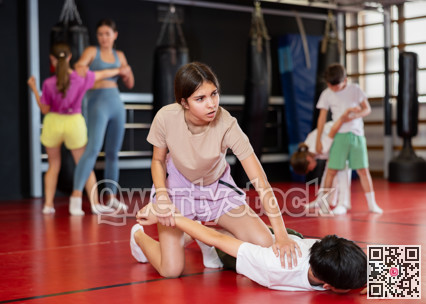 Teenage boy and girl practice self-defense in pairs