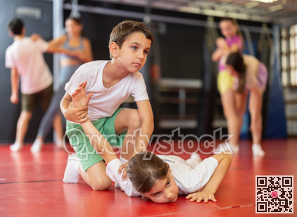Teenage girl sparring with boy during training