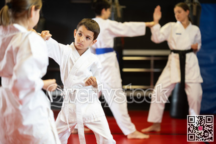 Boy and girl practice karate in pairs