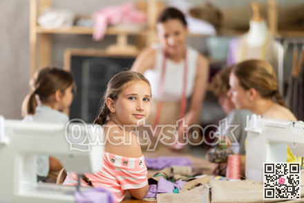 Portrait of happy teenage girl at sewing class