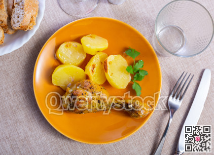 Chicken thigh served with potatoes on dinner plate