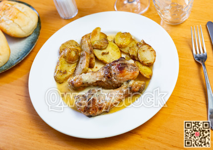 Chicken thigh served with potatoes on dinner plate