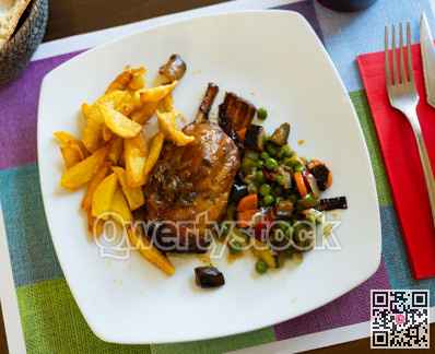 Baked chicken meat roll are garnished with baked vegetable mix and French fries potato.