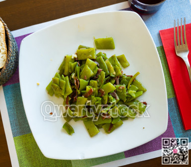 Dish of fried green beans with ham