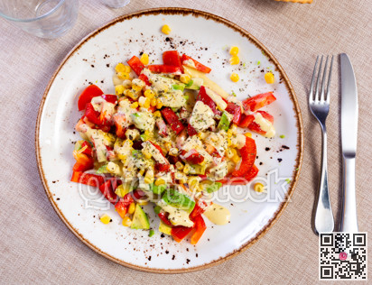 Fresh salad with avocado tomato bell pepper and corn