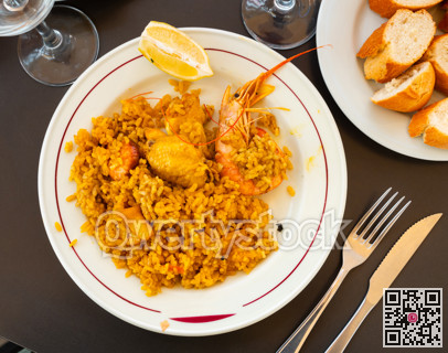 Chicken and seafood paella served in traditional pan