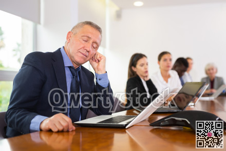 Man in suit sleeping during conference