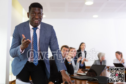 Managers expressing dissatisfaction with teamwork of colleagues at meeting