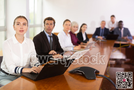 Woman secretary using laptop during conference