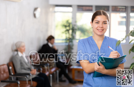 Young woman doctor makes notes in folder