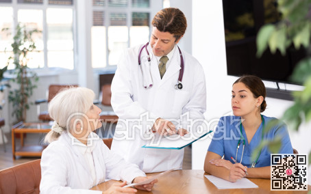 Group of professional doctors sitting at table and discussing diagnosis and treatment of patients during medical council