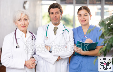 Portrait of two doctors and female nurse at office of medical clinic
