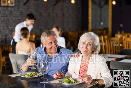 Happy senior couple having dinner together in restaurant