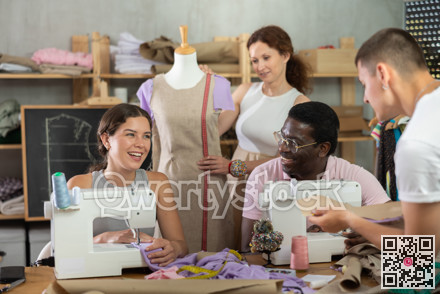Group of happy attendees of dressmaking courses engaged in different activities