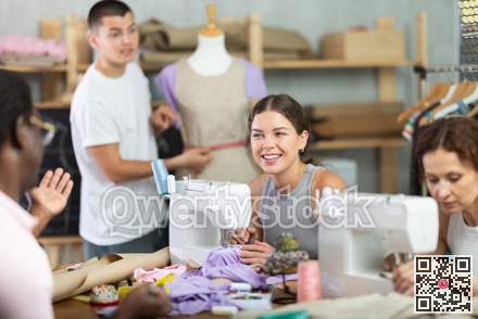 Young girl talking and sewing, other working with mannequin