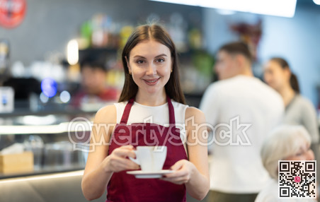 Portrait of female waiter in cafe interior