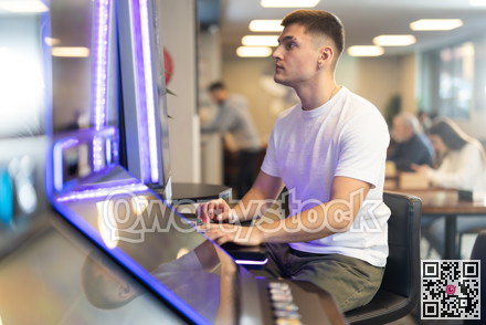 Guy is playing slot machines in casino