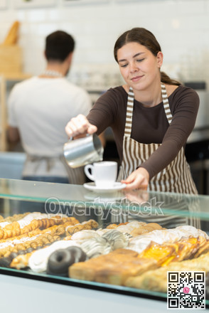 Girl cafe worker pours coffee from cezve coffee pot into cup