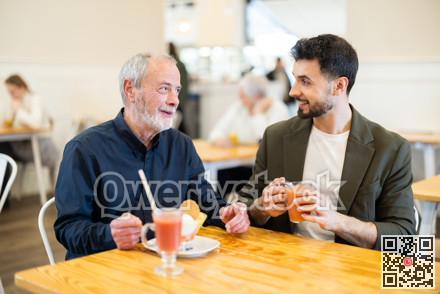 Two men are chatting at table in a cafe - eating ice cream and drinking juice