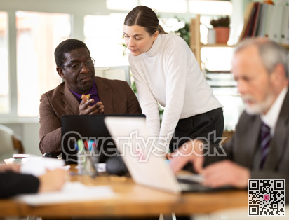 Management meeting in company office. Secretary distributes folders with documents