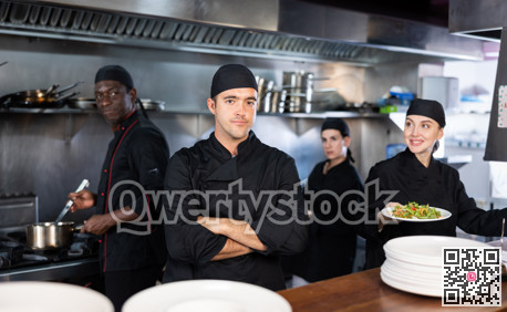 Portrait of confident chef with arms crossed in kitchen
