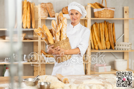 Female baker worker shows many products baguettes