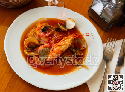 Monkfish tail in spicy sauce with shrimp and mussels