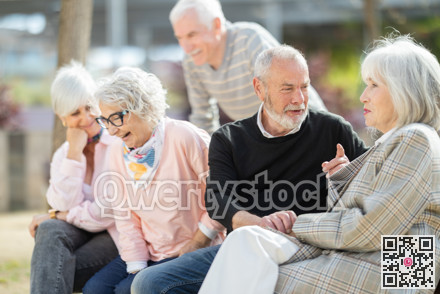 Senior friends chatting together while two of them flirting