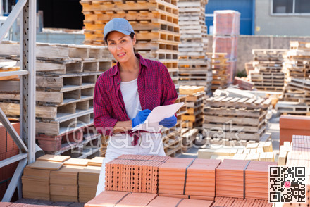 Woman manager leads the accounting of brick at construction site