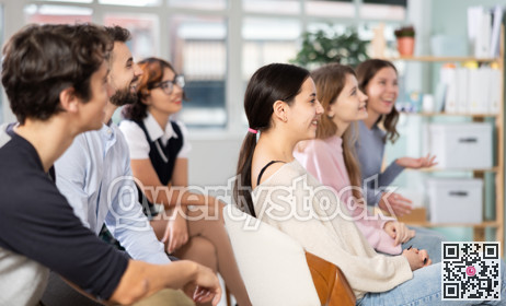 Group of happy students laughing during educational class