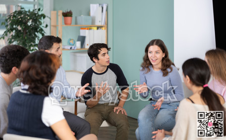 Students sitting in a circle and discussing a lecture