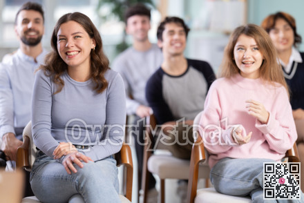 Group of happy students laughing during educational class